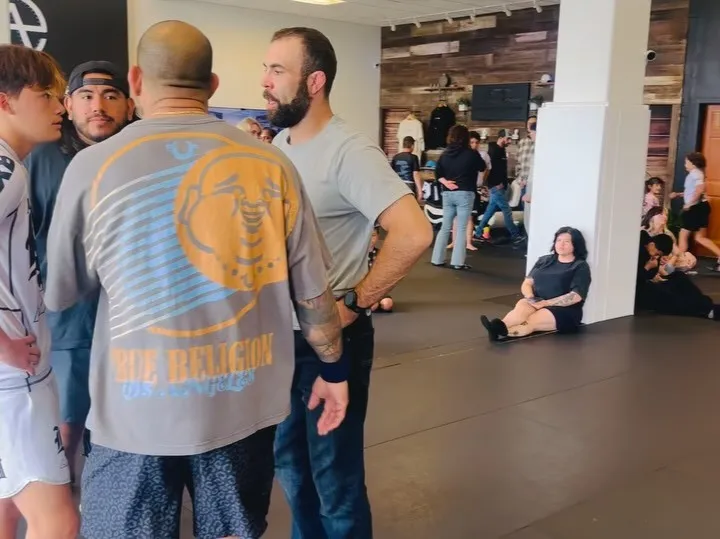 An AOE coach leading an adult No-Gi Brazilian Jiu-Jitsu class in Monterey