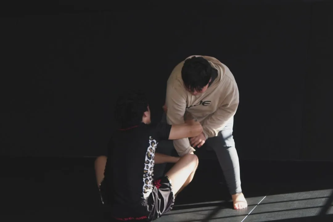 Adults drilling No-Gi Brazilian Jiu-Jitsu partner techniques at AOE in Monterey