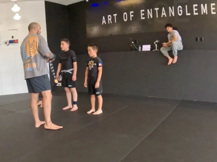 A family training Brazilian Jiu-Jitsu together on the mats at AOE in Monterey